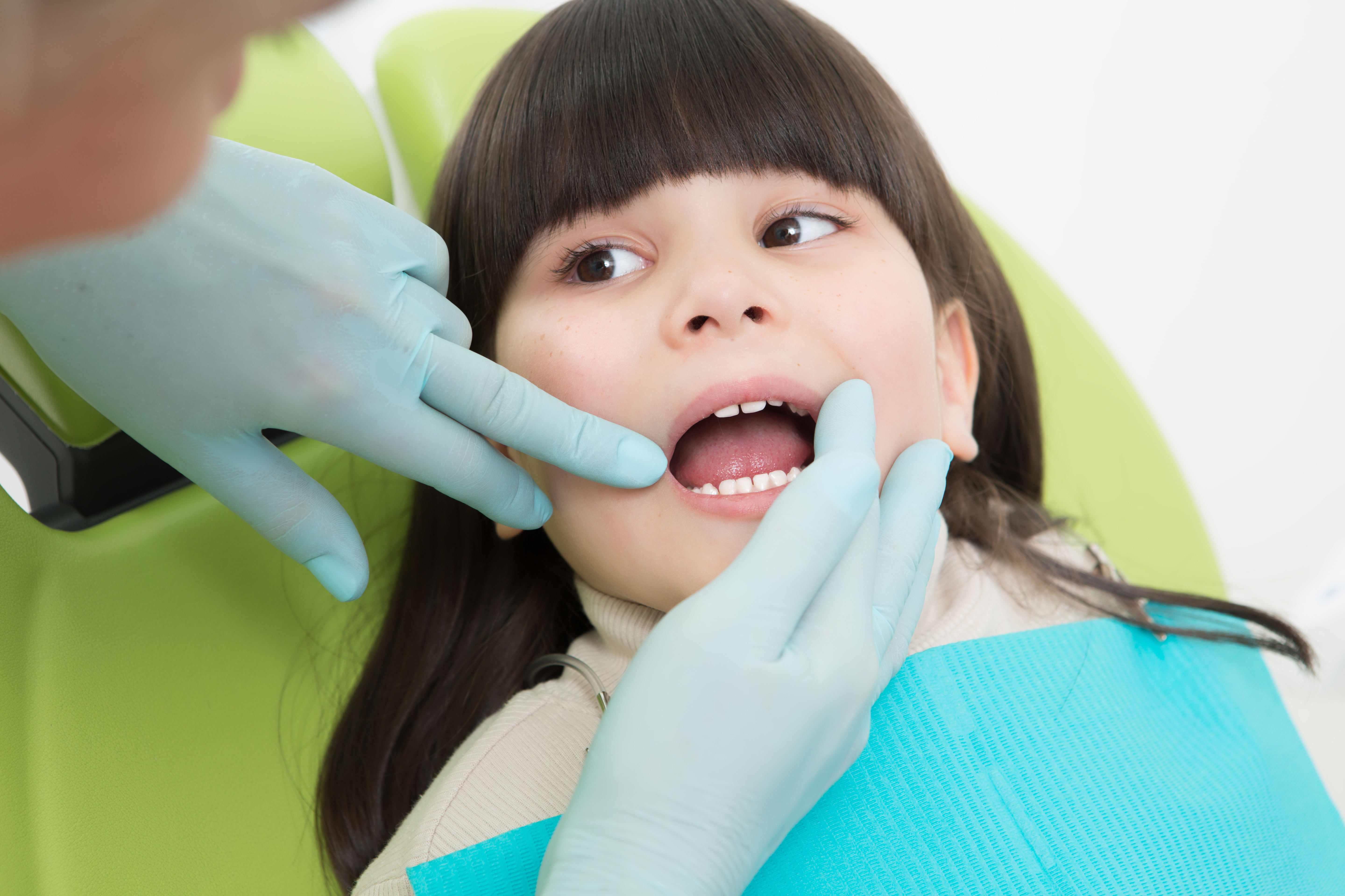 close-up-little-girl-having-her-teeth-examined-by-dentist