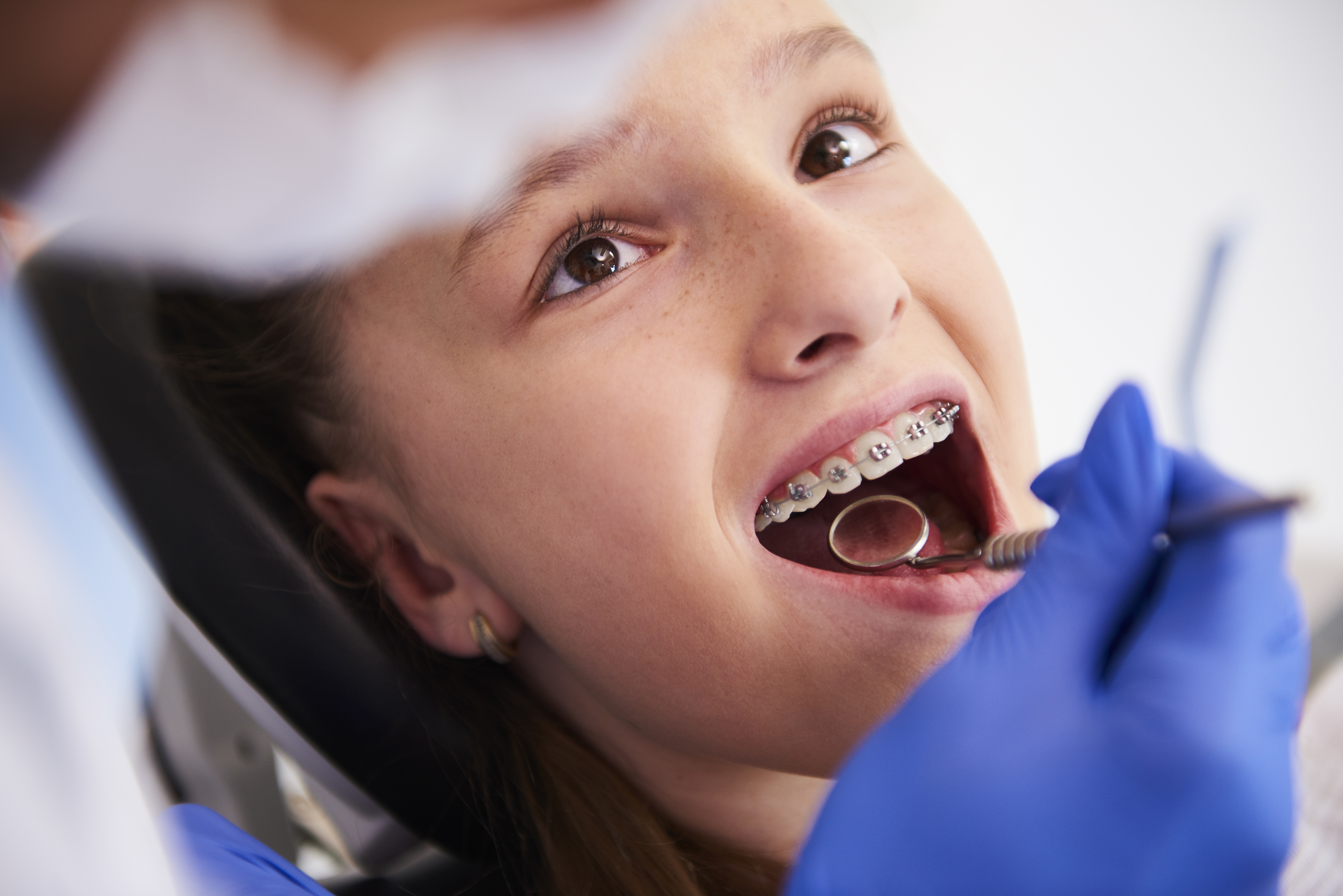 girl-with-braces-routine-dental-examination
