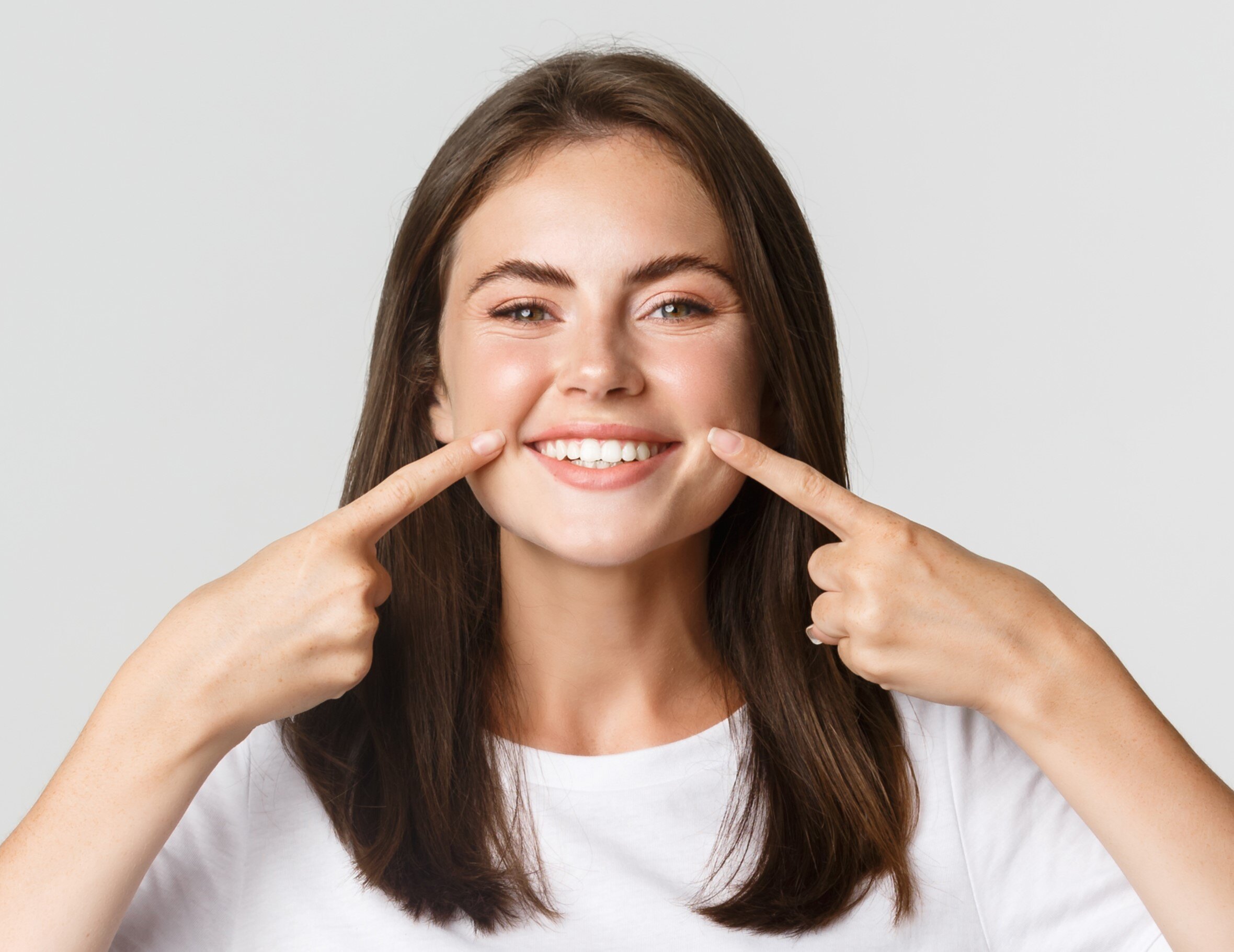 happy-girl-pointing-fingers-mouth-showing-white-perfect-teeth-beautiful-smile